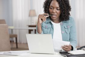 African American woman paying bills