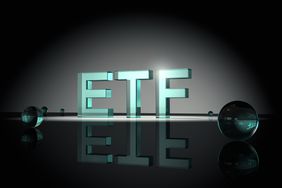 Large neon-lit letters spelling ETF