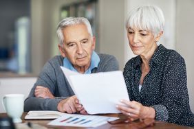 older couple Looking at their individual retirement accounts