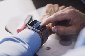 A man checking his index funds on his smart watch