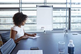 Businesswoman taking notes in conference room