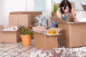 Woman unpacking cardboard boxes
