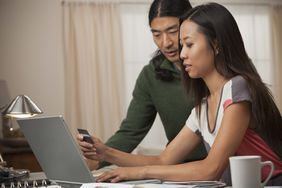 Couple entering credit card information at a computer