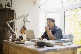 Man working at laptop in home office