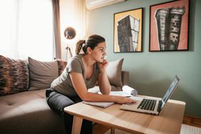 Businesswoman working from home on laptop