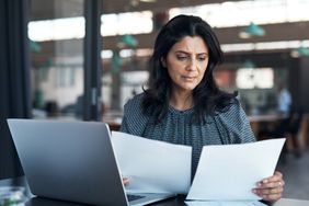 Woman looking at papers in office