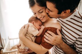 Mother and father taking care of newborn son