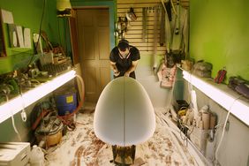 Shaper shapes a board at a Maine surf shop