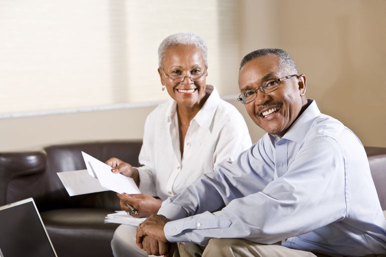 Older couple paying bills online