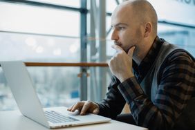 Man reviewing document on laptop