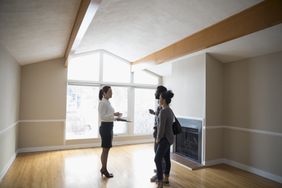 Realtor showing new house to young couple