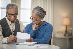 Senior African American couple paying bills