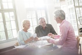 Older couple discussing paperwork with an advisor