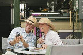 A couple looks at photos on a digital camera.