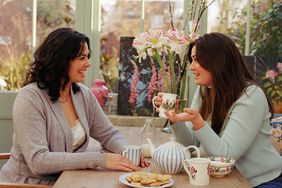 two young women having a conversation over coffee