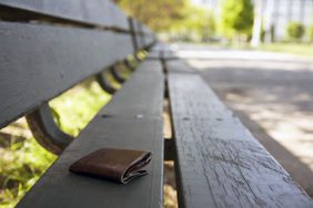 Lost wallet laying on a park bench