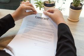 Man ripping contract at desk