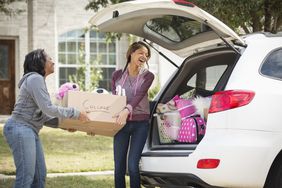 Mom helping daughter load her car to move to college