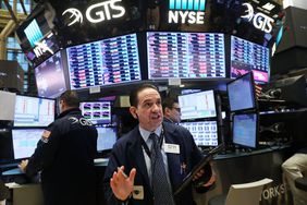 Traders work on the floor of the New York Stock Exchange (NYSE) on February 6, 2018 in New York City. Following Monday's over 1000 point drop, the Dow Jones Industrial Average briefly fell over 500 points in morning trading.