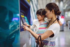 Parent and child and using ATM at train station