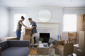 Couple in new home unpacking boxes