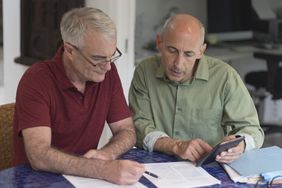 Two people reviewing paperwork at home