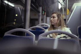 Young woman rides home on bus in Cyprus