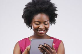 Smiling woman working on a tablet