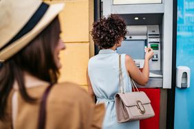 Woman withdrawing money at an ATM outdoors