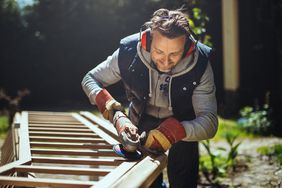 man doing home renovation work on fence