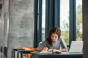 Asian student studying in library