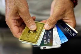 Man holding several credit cards with various interest rates
