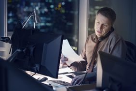Businessman working late at computer in office