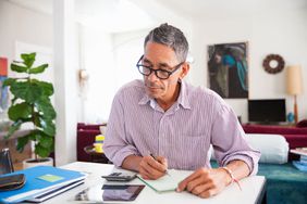 Mature man doing working at home