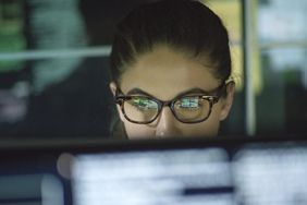 Woman at computer monitoring stock data