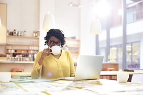 Creative woman working at desk with coffee
