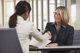 Businesswomen shaking hands in a job interview
