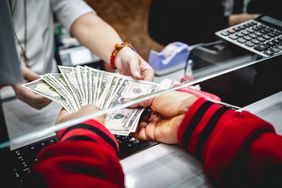 American currency changing hands at cash window