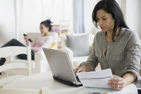 A picture of a mom paying her bill online